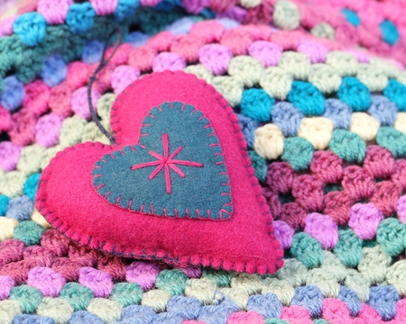 pink and blue felt shabby chic heart on a crochet afghan blanket