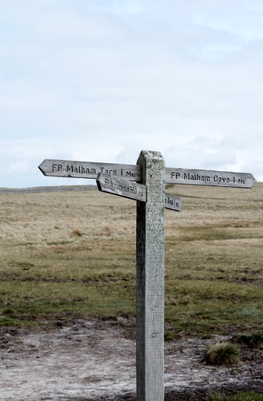 Wooden sign post on moors at Malham Cove, Yorkshire, UKの写真素材