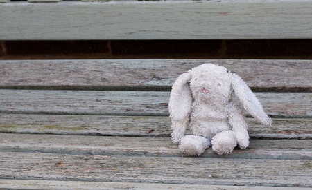 Abandoned old toy rabbit, much loved childs toy lost and waitingの写真素材