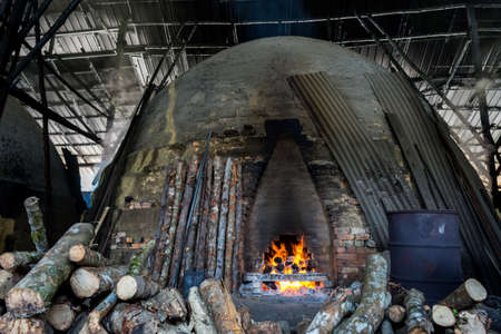 traditional charcoal kiln with charcoal under production with mangrove (Rhizophora sp) woodのeditorial素材