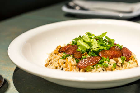 Chinese fried rice with sausage and coriander on topのeditorial素材