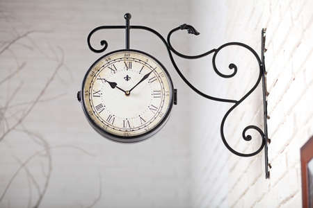 Black vintage watch with Roman numerals in the white studio interiorの写真素材