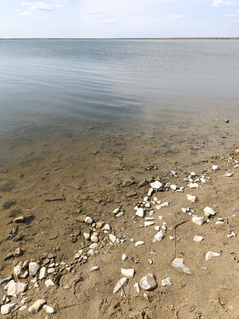 Sandy riverbank with rocks. River beach.の写真素材