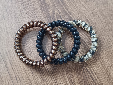 Spiral hair ties. Hair accessories in brown and black. Jewelry for girls.の写真素材