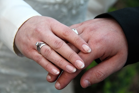 Hands of bridal couple with wedding ringsの写真素材