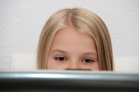 Young Girl Using Laptop At Homeの写真素材