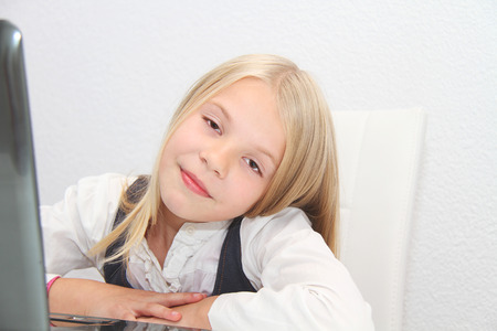 Young Girl Using Laptop At Homeの写真素材