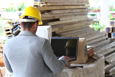 Engineer at a construction site making a business call