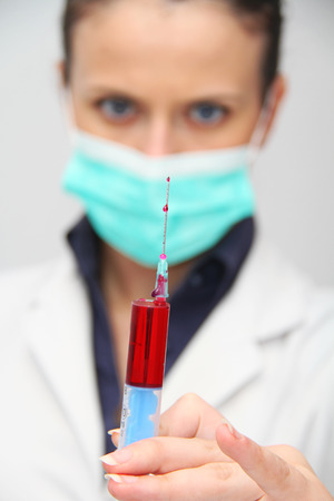 Syringe of Red Blood Test for research HIV AIDS Concept Ideaの写真素材