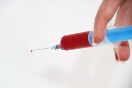 Syringe of Red Blood Test for research HIV AIDS Concept Ideaの写真素材