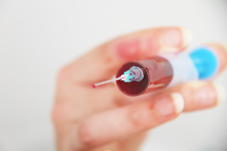 Syringe of Red Blood Test for research HIV AIDS Concept Ideaの写真素材