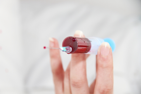 Syringe of Red Blood Test for research HIV AIDS Concept Ideaの写真素材
