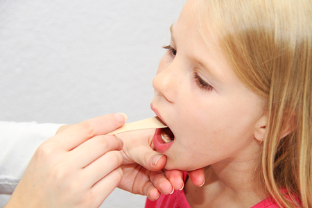 Young female child examined by woman doctorの写真素材