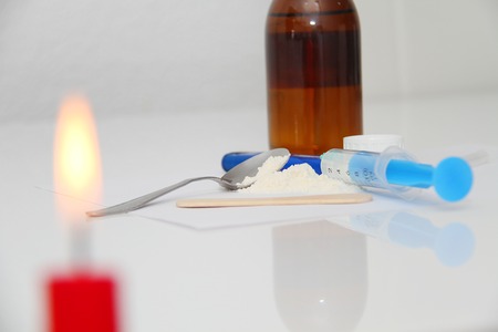 Drug syringe and cooked heroin on spoonの写真素材