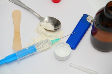 Drug syringe and cooked heroin on spoonの写真素材