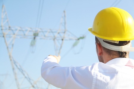 Male engineer standing at electricity station