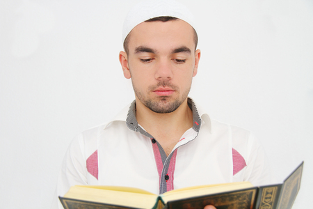 Young man reading the Holy Koranの写真素材