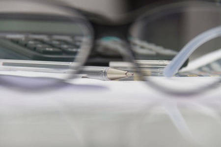 Photo of the Businessman analyzing investment charts with calculator and laptopの写真素材