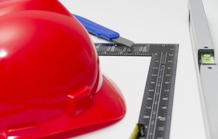 Photo of the Helmet and tools for construction drawings and buildings