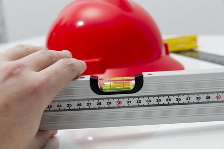 Photo of the Helmet and tools for construction drawings and buildings