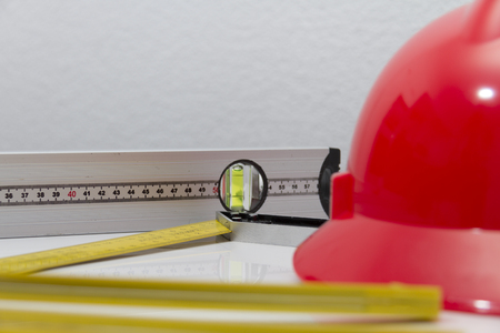 Photo of the Helmet and tools for construction drawings and buildingsの写真素材