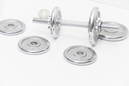 Photo of the Fitness concept with Grey dumbbells and loose weightsの写真素材
