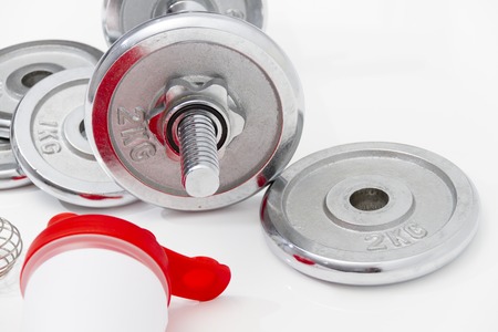 Photo of the Fitness concept with Grey dumbbells and loose weightsの写真素材