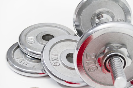 Photo of the Fitness concept with Grey dumbbells and loose weightsの写真素材