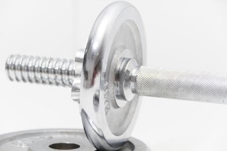 Photo of the Fitness concept with Grey dumbbells and loose weightsの写真素材