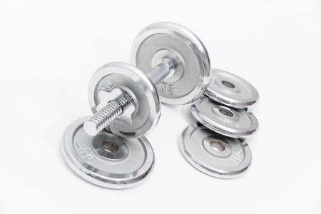 Photo of the Fitness concept with Grey dumbbells and loose weightsの写真素材