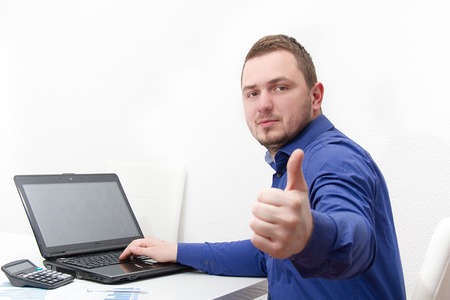 Photo of the Happy young business man work in modern office on computerの写真素材