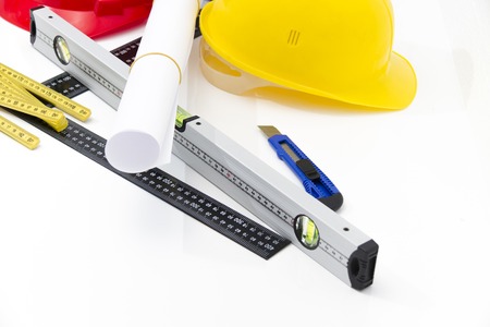 Photo of theColorful helmets and tools for construction drawings and buildingsの写真素材