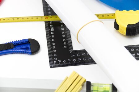 Photo of theColorful helmets and tools for construction drawings and buildings