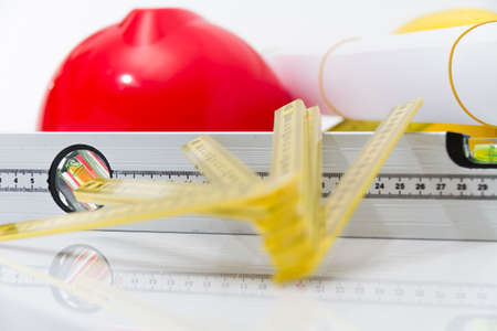 Photo of theColorful helmets and tools for construction drawings and buildings