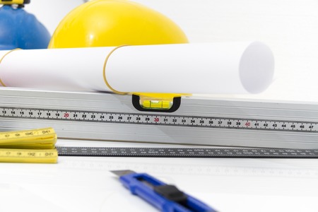 Photo of theColorful helmets and tools for construction drawings and buildings
