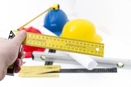 Photo of theColorful helmets and tools for construction drawings and buildingsの写真素材