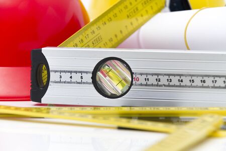 Photo of theColorful helmets and tools for construction drawings and buildings