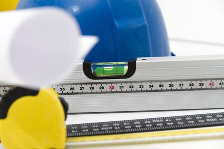 Photo of theColorful helmets and tools for construction drawings and buildingsの写真素材