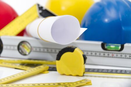 Photo of theColorful helmets and tools for construction drawings and buildings