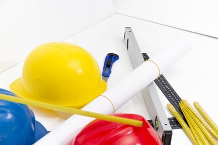Photo of theColorful helmets and tools for construction drawings and buildings