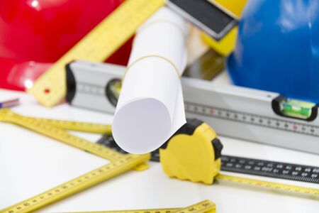 Photo of theColorful helmets and tools for construction drawings and buildings