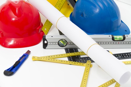 Photo of theColorful helmets and tools for construction drawings and buildings