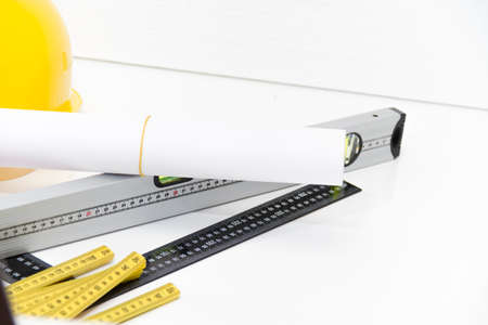 Photo of theColorful helmets and tools for construction drawings and buildingsの写真素材