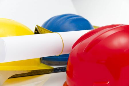 Photo of theColorful helmets and tools for construction drawings and buildings