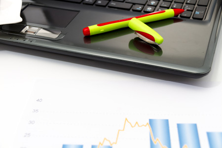Photo of the Analyzing business investment charts with calculator and laptopの写真素材
