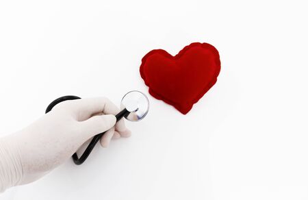 Stethoscope listening to a healthy red heartの写真素材