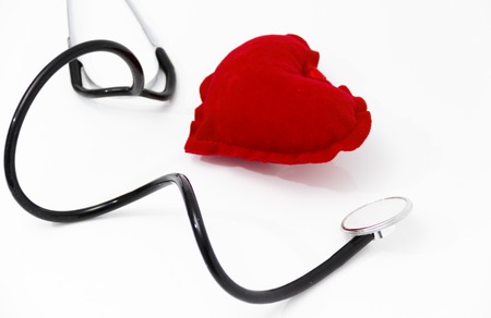 Stethoscope listening to a healthy red heartの写真素材