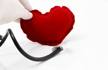 Stethoscope listening to a healthy red heartの写真素材