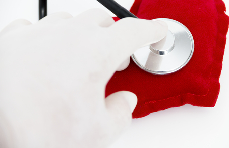 Stethoscope listening to a healthy red heartの写真素材