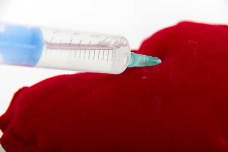 Photo of the Syringe injecting a red heart and health concept, healthy lifeの写真素材